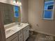 Modern bathroom with a double sink vanity, large mirror, and a combined shower and bathtub at 8231 Annsborough Nw Dr, Concord, NC 28027