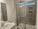 Bathroom featuring a tiled shower with a glass door and a single sink vanity at 8231 Annsborough Nw Dr, Concord, NC 28027