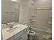 Bathroom with a white vanity, a large mirror, and a shower-tub combo for a functional design at 8231 Annsborough Nw Dr, Concord, NC 28027
