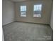 Bright bedroom with two large windows providing lots of natural light and outdoor views at 8231 Annsborough Nw Dr, Concord, NC 28027