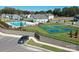 Aerial shot featuring a community pool, tennis courts, parking and lush landscaping at 8231 Annsborough Nw Dr, Concord, NC 28027