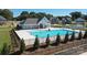 Aerial view of a community pool with lounge chairs, landscaping, and surrounding residential buildings at 8231 Annsborough Nw Dr, Concord, NC 28027