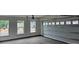 A spacious garage featuring a roll-up door and natural light, offering ample room for parking and storage at 8231 Annsborough Nw Dr, Concord, NC 28027