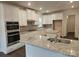 Modern kitchen with granite countertops, white cabinets, stainless steel appliances, and center island at 8231 Annsborough Nw Dr, Concord, NC 28027