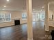 Open concept living room with hardwood floors, fireplace, recessed lighting, and large windows at 8231 Annsborough Nw Dr, Concord, NC 28027