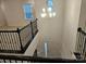 View of staircase with dark railings and stairs plus a large chandelier at 8231 Annsborough Nw Dr, Concord, NC 28027