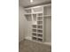 Walk-in closet showcasing carpet and custom storage solutions with ample shelving for clothing at 8231 Annsborough Nw Dr, Concord, NC 28027