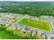 Aerial view featuring a green space, neighborhood homes, and lush surrounding forestry at 972 Von Buren Blvd # 242, Rock Hill, SC 29730