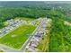 Aerial view displays homes in a green neighborhood with street and community parkway at 972 Von Buren Blvd # 242, Rock Hill, SC 29730