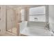 Bright bathroom features a glass shower, large soaking tub and a large window with natural light at 972 Von Buren Blvd # 242, Rock Hill, SC 29730