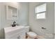 Well-lit powder room with sleek black hardware and white fixtures at 972 Von Buren Blvd # 242, Rock Hill, SC 29730