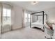 A bedroom featuring a canopy bed, light-colored walls and carpet, and bright natural lighting at 972 Von Buren Blvd # 242, Rock Hill, SC 29730