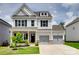 Beautiful two-story home featuring gray siding, brick accents, and a well-manicured front yard at 972 Von Buren Blvd # 242, Rock Hill, SC 29730