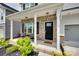 Inviting covered front porch with brick accents and black chairs creates a cozy entryway at 972 Von Buren Blvd # 242, Rock Hill, SC 29730