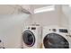 Bright laundry room featuring a new washer and dryer, wire shelving and a window at 972 Von Buren Blvd # 242, Rock Hill, SC 29730