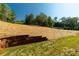 View of a straw-covered hill and retaining wall in the backyard of a single-Gathering home at 10180 Lakeshore Dr, Lancaster, SC 29720