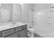 Bathroom featuring a vanity with gray cabinets, a toilet, and a shower-tub combo at 10180 Lakeshore Dr, Lancaster, SC 29720