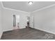 A bright bedroom with hardwood floors, white trim, and two doors leading to other areas of the house at 10180 Lakeshore Dr, Lancaster, SC 29720