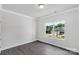 Bright, neutral bedroom with hardwood floors and a large window at 10180 Lakeshore Dr, Lancaster, SC 29720