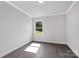 Minimalist bedroom featuring hardwood floors, white trim, and a bright window at 10180 Lakeshore Dr, Lancaster, SC 29720