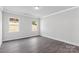 Bright bedroom featuring hardwood floors and ample natural light from two windows at 10180 Lakeshore Dr, Lancaster, SC 29720