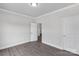 Neutral bedroom features hardwood floors, white trim, and two closets at 10180 Lakeshore Dr, Lancaster, SC 29720