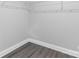 Empty walk-in closet with gray wood floor and white wire rack shelving at 10180 Lakeshore Dr, Lancaster, SC 29720