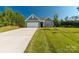 Attractive single-Gathering home with a well-kept lawn, an attached garage, and tasteful gray siding at 10180 Lakeshore Dr, Lancaster, SC 29720