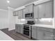 Modern kitchen features gray cabinets, herringbone backsplash, and stainless steel appliances at 10180 Lakeshore Dr, Lancaster, SC 29720