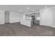 Well-lit open kitchen and living space with modern appliances, gray cabinets, and a center island at 10180 Lakeshore Dr, Lancaster, SC 29720