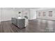 Open-concept kitchen features a central island, modern appliances, and beautiful hardwood floors at 10180 Lakeshore Dr, Lancaster, SC 29720