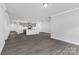 Spacious living area with gray hardwood floors, recessed lighting, and a view of the kitchen at 10180 Lakeshore Dr, Lancaster, SC 29720