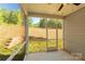 Screened-in patio with view of backyard retaining wall and wooded area at 10180 Lakeshore Dr, Lancaster, SC 29720