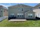 Backyard of home featuring vinyl siding, a patio, and a well manicured lawn at 107 Ameena Chase Trl, Mooresville, NC 28117