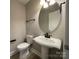 Powder room features a pedestal sink, black fixtures and a round mirror at 107 Ameena Chase Trl, Mooresville, NC 28117