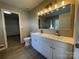 Bathroom features a double sink vanity, a large mirror, and modern lighting at 107 Ameena Chase Trl, Mooresville, NC 28117