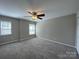 A spacious bedroom is enhanced by natural light, ceiling fan, and plush carpeting at 107 Ameena Chase Trl, Mooresville, NC 28117