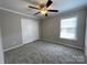 Bedroom features neutral paint, carpet, and a closet with bi-fold doors at 107 Ameena Chase Trl, Mooresville, NC 28117