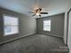 This bedroom features neutral walls, plush carpet, and bright natural light at 107 Ameena Chase Trl, Mooresville, NC 28117
