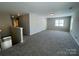 Spacious bonus room features neutral paint, wall-to-wall carpeting, and a window at 107 Ameena Chase Trl, Mooresville, NC 28117