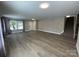 Bright living room with new floors, staircase and multiple windows at 107 Ameena Chase Trl, Mooresville, NC 28117