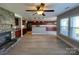 Open layout showcasing stone fireplace, kitchen, and modern flooring at 107 Ameena Chase Trl, Mooresville, NC 28117