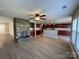 Open layout showcasing stone fireplace, kitchen, and modern flooring at 107 Ameena Chase Trl, Mooresville, NC 28117