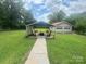 Backyard canopy area with seating offers an excellent outdoor retreat, close to the detached garage at 1107 Crestfield Dr, Lancaster, SC 29720