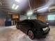 Spacious garage featuring a sleek black car, ample storage, and bright lighting for automotive enthusiasts at 1107 Crestfield Dr, Lancaster, SC 29720