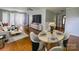 Open-concept living area with hardwood floors, a dining nook, and modern furnishings perfect for entertaining at 1107 Crestfield Dr, Lancaster, SC 29720