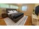 Stylish bedroom with wood floors, a plush bed, and modern accents creating a comfortable and inviting space at 1107 Crestfield Dr, Lancaster, SC 29720