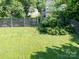A spacious backyard featuring a well-maintained lawn and a sturdy wooden fence for privacy at 11911 Brownestone View Dr, Charlotte, NC 28269