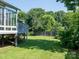 Spacious backyard features a deck, sunroom, and well-maintained lawn at 11911 Brownestone View Dr, Charlotte, NC 28269