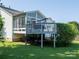 Spacious backyard features a deck, sunroom, and well-maintained lawn at 11911 Brownestone View Dr, Charlotte, NC 28269